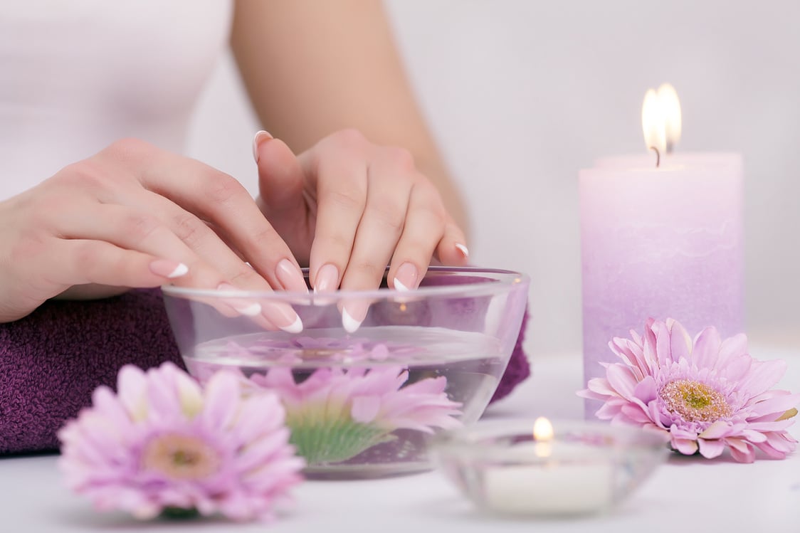 Woman Soaking Her Nails in Nail Salon